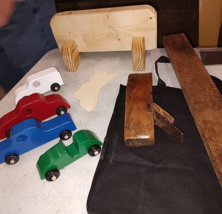 Bob Shoffner coffin plane and level, Mark's Japanese sawhorse, Richard's wood cars with patterns.